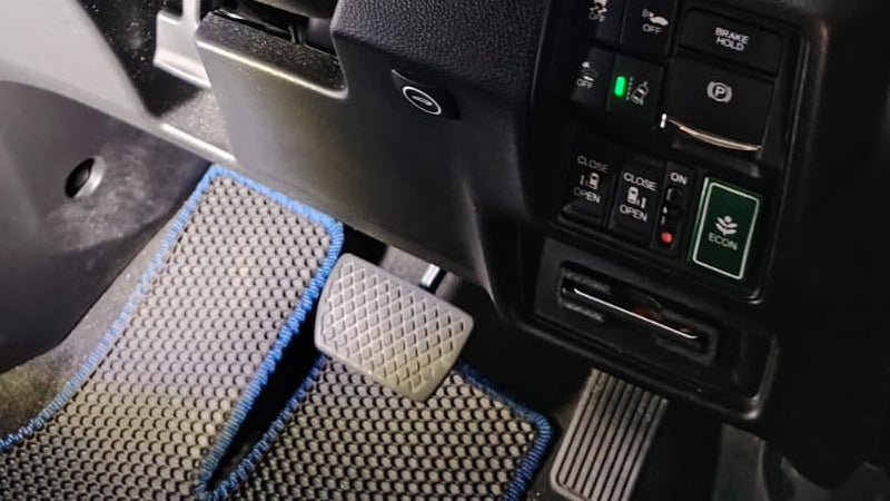 Car interior with steering wheel and dashboard in a vehicle.